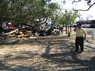 Man inspecting rubble from hurricane Katrina